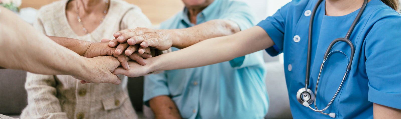 Background of elderly human bare hands join together in the middle under with indoors light. Concept Elderly nursing care help and support. Service mind for senior people.